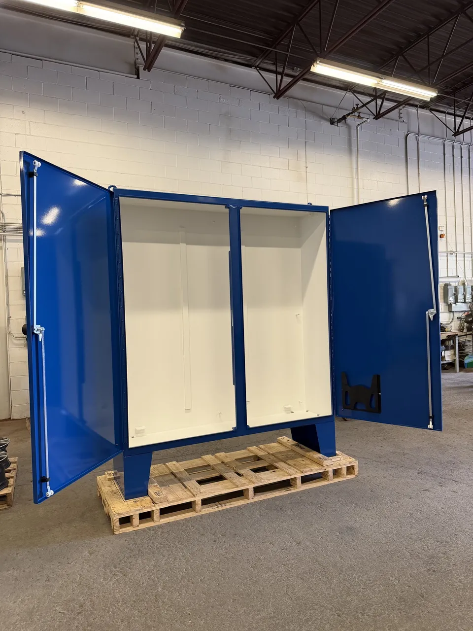 Pair of blue powder-coated electrical cabinets with white interiors