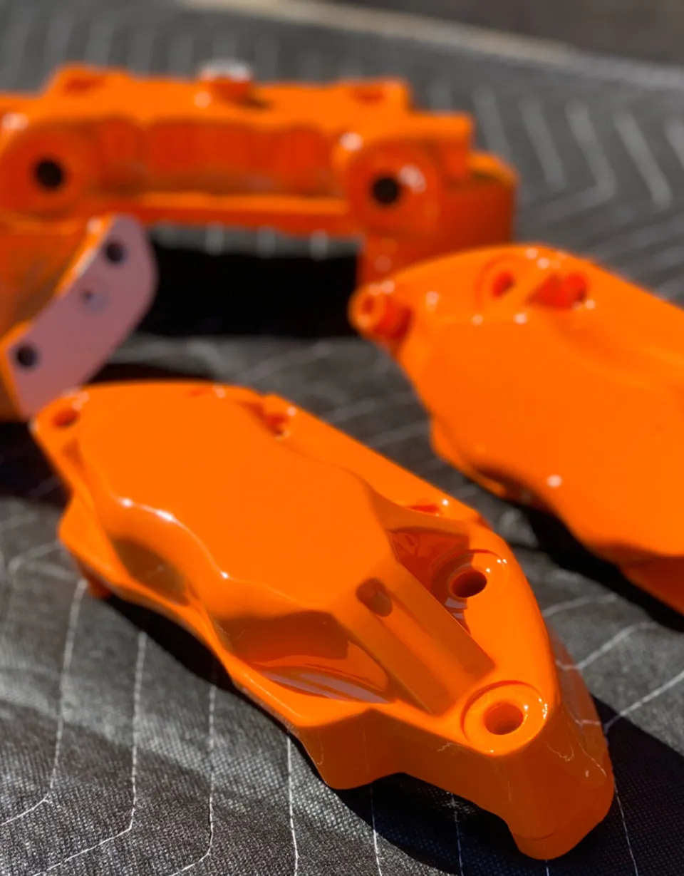 Bright orange powder-coated brake calipers