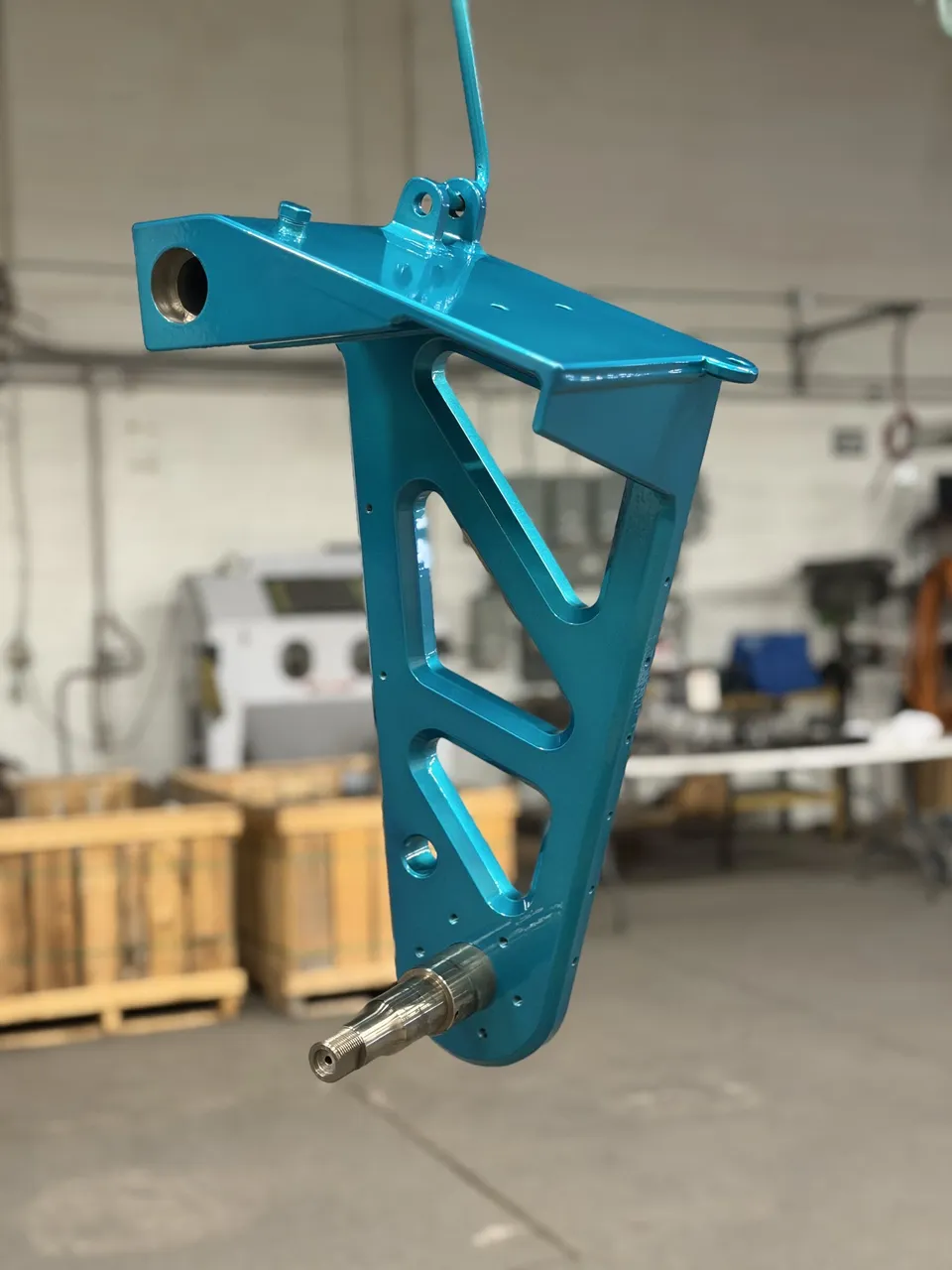 Teal powder-coated machined bracket