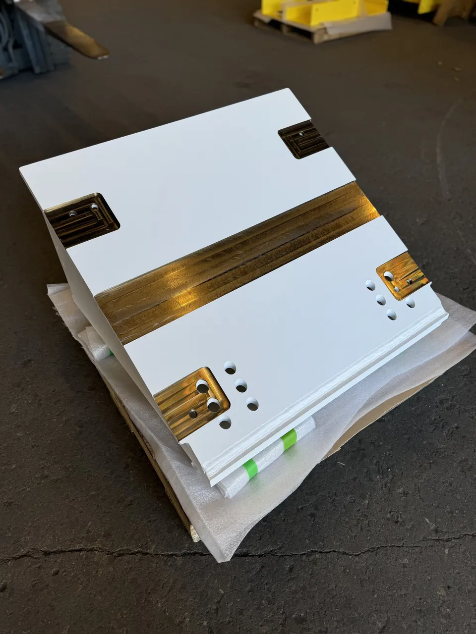 White powder-coated panels with masked brass contact strips